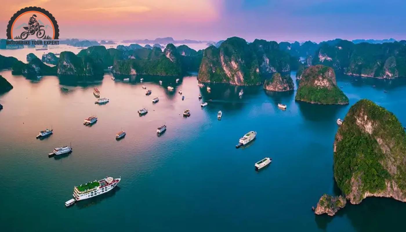 Sunset casts a warm glow over the majestic limestone karsts of Ha Long Bay