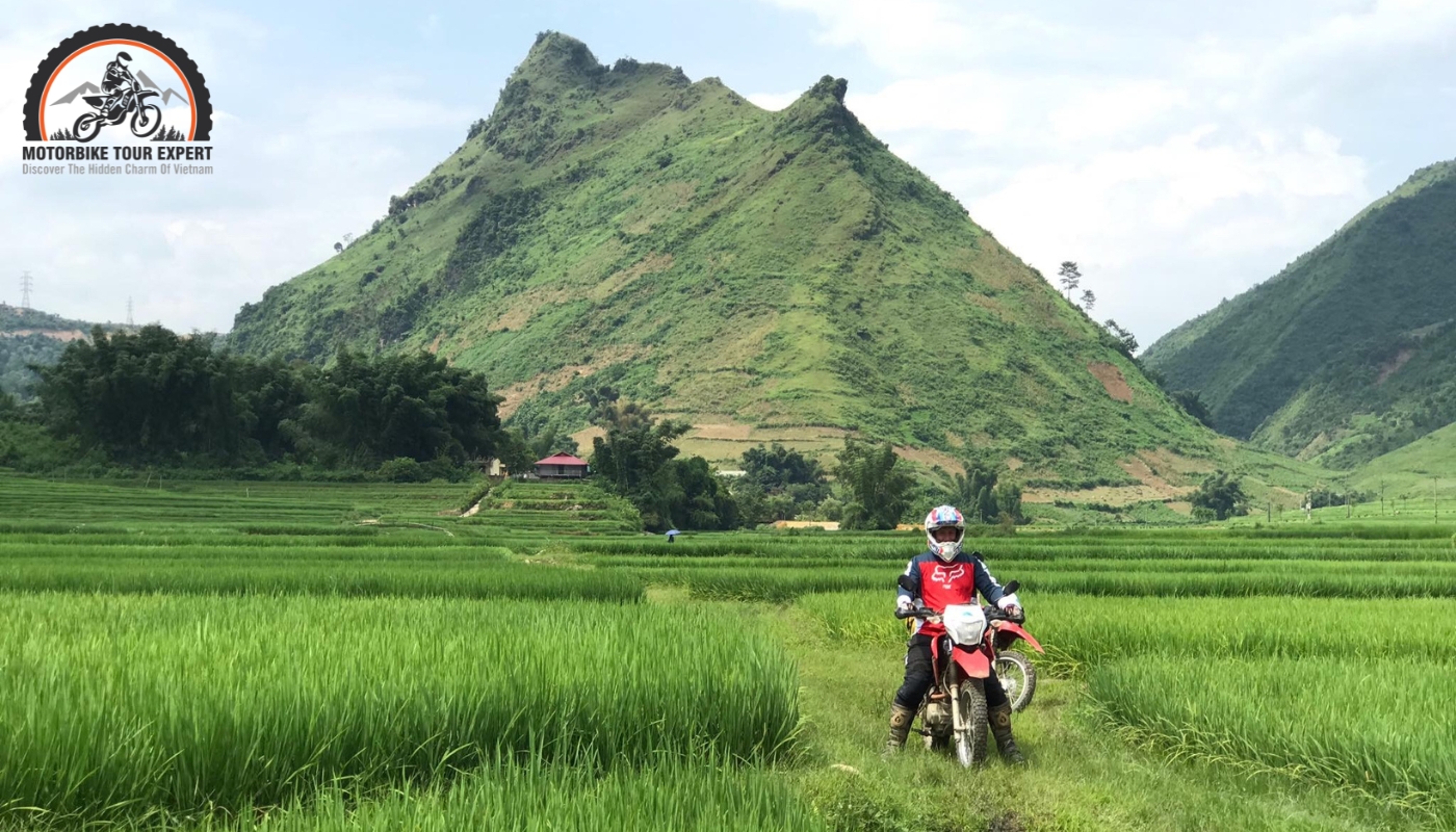 Breathtaking coastal view with a motorbike rider on the road