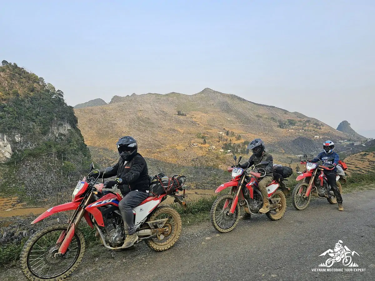 Motorbike riders traveling along a mountain road in Northern Vietnam.