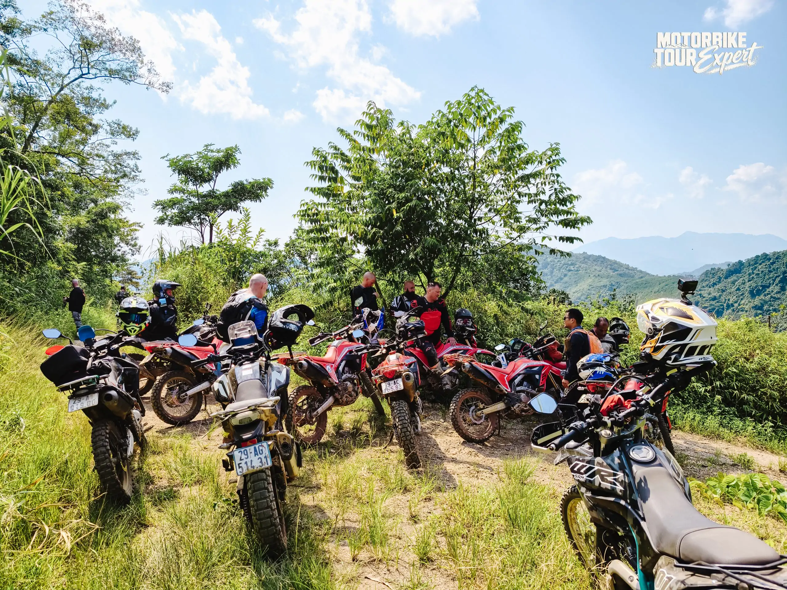 Motorcycle tour group exploring the scenic mountains of Northern Vietnam.