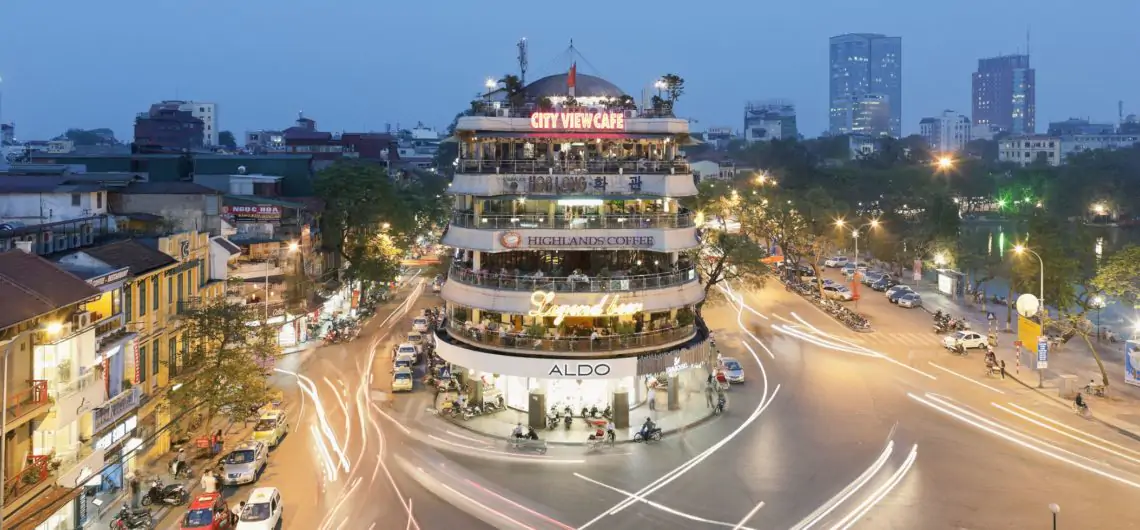 Hanoi Old Quarter at night with bustling streets and illuminated city views.