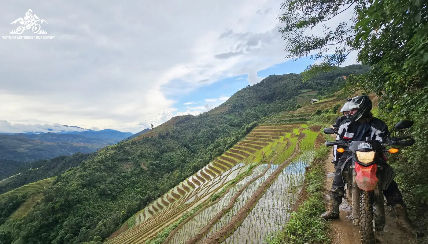 Motorbike rider traveling alongside the rice terraces of Mu Cang Chai in Northern Vietnam.