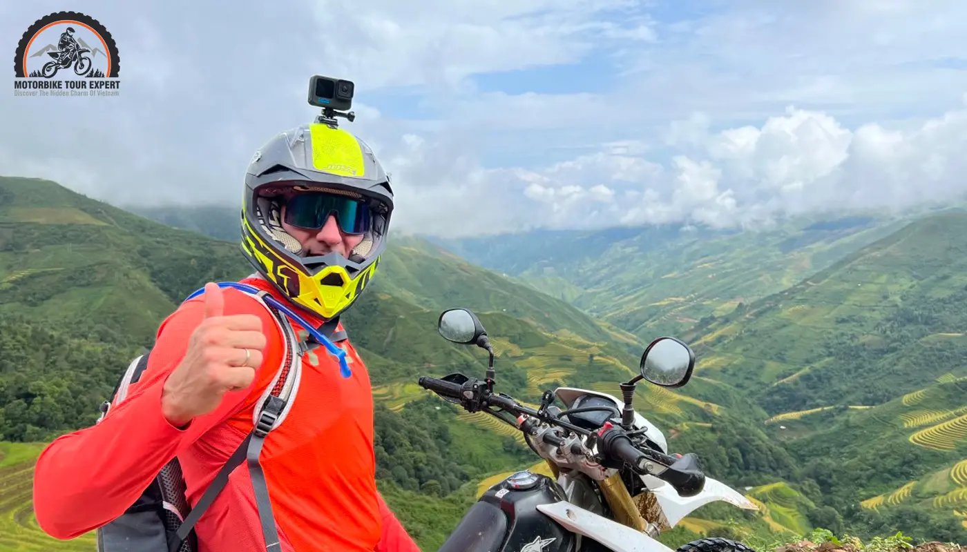 Motorbike rider exploring the mountain roads of Northern Vietnam, surrounded by terraced rice fields.